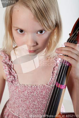 Image of Portrait of a young teenager girl in studio with a cello