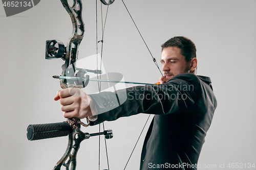 Image of Businessman aiming at target with bow and arrow, isolated on white background