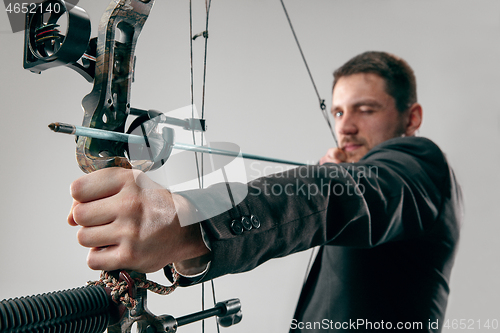 Image of Businessman aiming at target with bow and arrow, isolated on white background