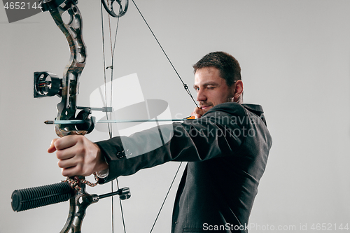 Image of Businessman aiming at target with bow and arrow, isolated on white background