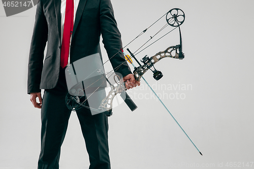 Image of Businessman aiming at target with bow and arrow, isolated on white background