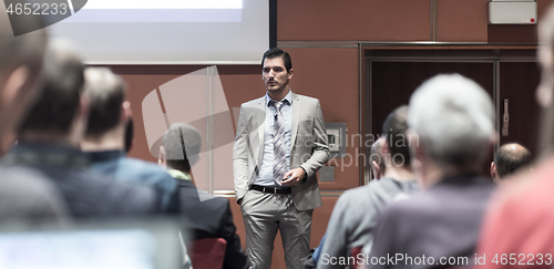Image of Business speaker giving a talk at business conference meeting event.
