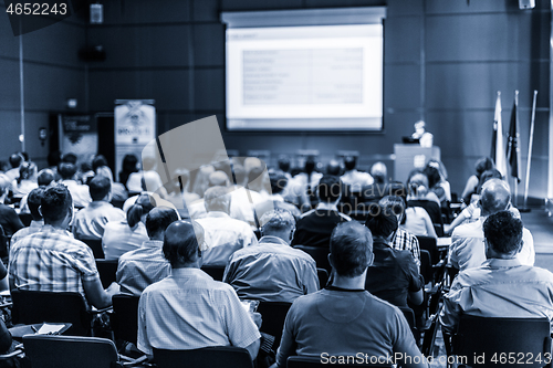 Image of Woman giving presentation in lecture hall at university.