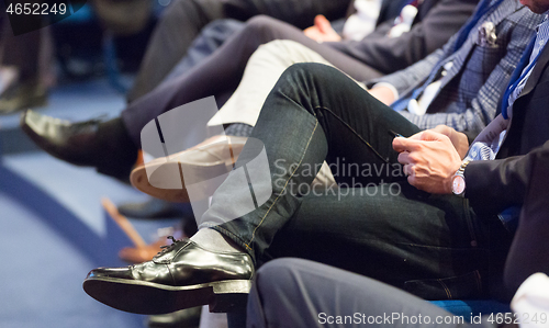 Image of Row of business people sitting at seminar.