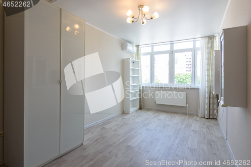 Image of Room interior with wardrobe and hanging cupboards