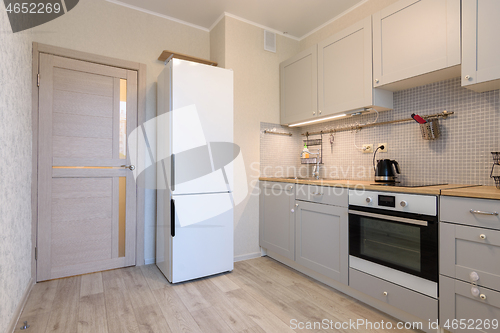 Image of The interior of a small cozy kitchen in the apartment, the interior door to the kitchen is closed