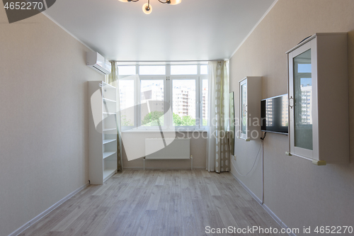 Image of Partially empty room in the apartment with large windows