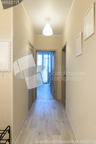 Image of Corridor in a one-room apartment, a balcony in the distance