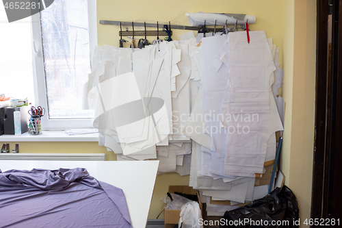 Image of a lot of patterns hang on the wall in the sewing workshop