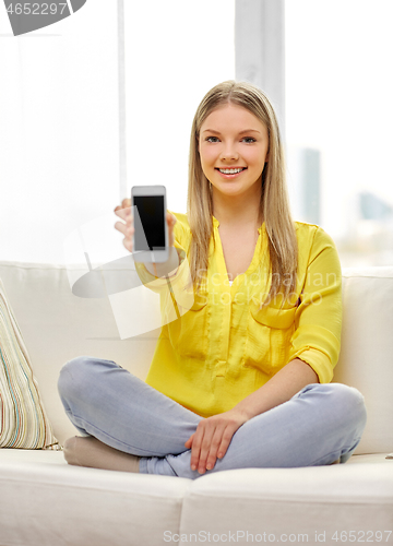 Image of young woman or teen girl with smartphone at home