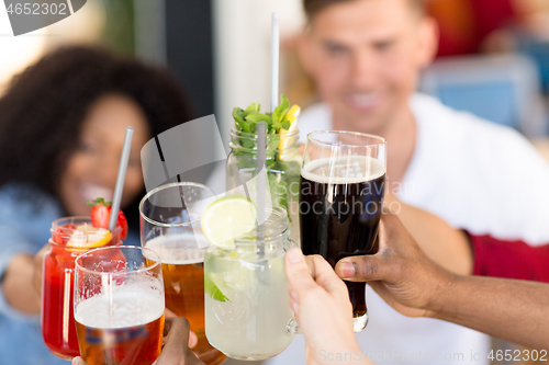 Image of friends clinking glasses at bar or restaurant