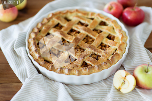 Image of close up of apple pie in baking mold on towel