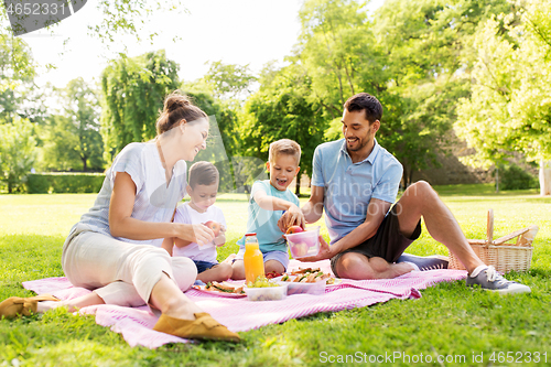 Image of happy family having picnic at summer park