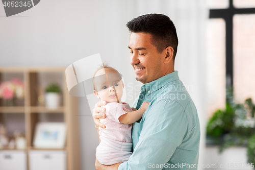 Image of middle aged father with baby daughter at home