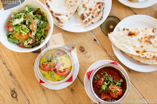 Image of various food on table of indian restaurant