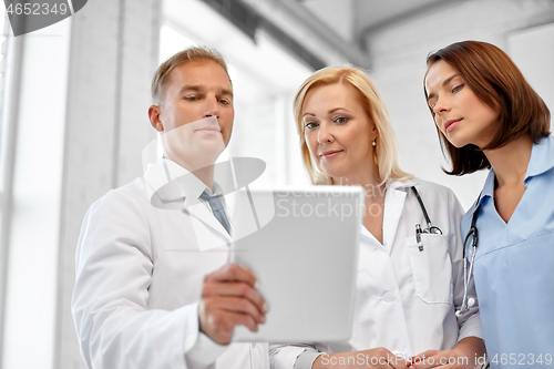 Image of group of doctors with tablet computer at hospital