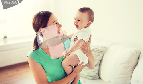 Image of happy young mother with little baby at home