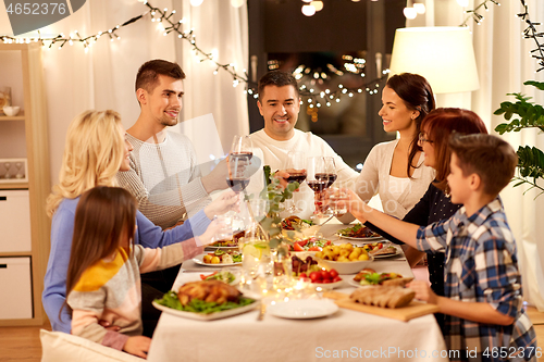 Image of happy family having dinner party at home