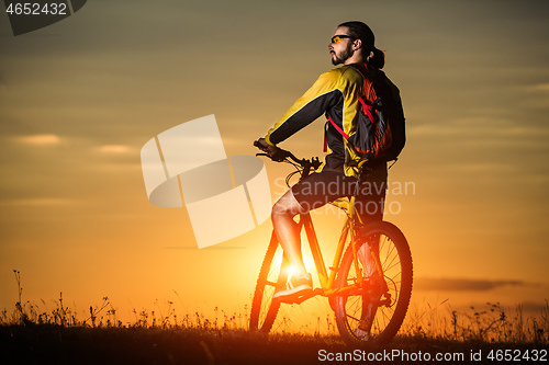 Image of silhouette of the cyclist riding a road bike at sunset