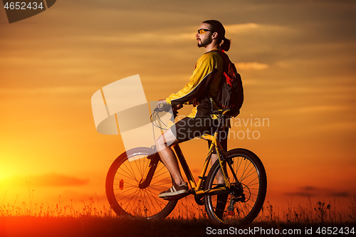 Image of silhouette of the cyclist riding a road bike at sunset