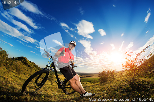 Image of Low angle view of man riding bicycle against sky