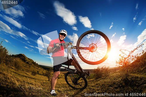 Image of Low angle view of man riding bicycle against sky