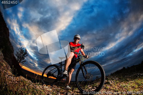 Image of cyclist riding a bike on nature trail in the mountains.