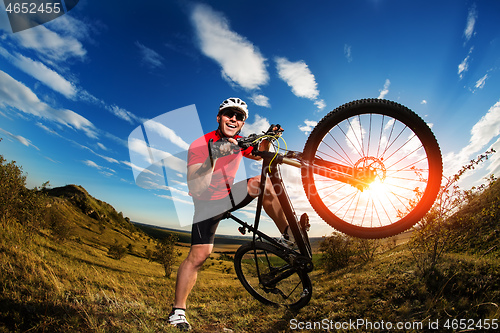 Image of Low angle view of man riding bicycle against sky