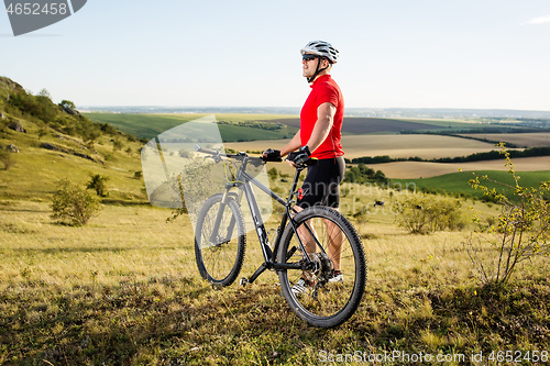 Image of Low angle view of man riding bicycle against sky