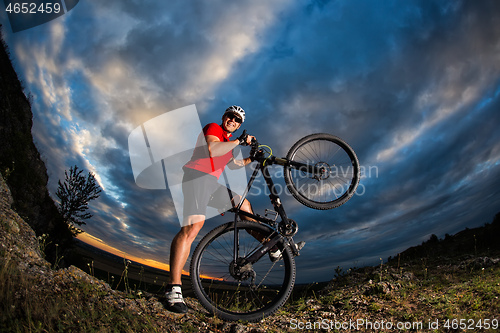 Image of cyclist riding a bike on nature trail in the mountains.