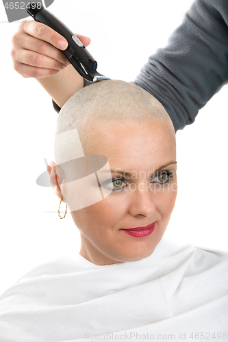 Image of beautiful middle age woman cancer patient shaving hair