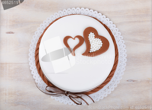 Image of valentine love cake with hearts on wooden background