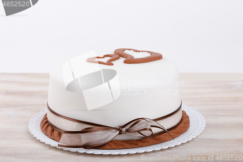 Image of valentine love cake with hearts on wooden background