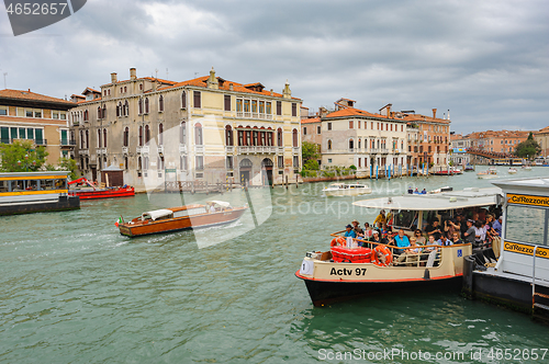 Image of Venice, Italy. Small passenger ship carries tourists across the city