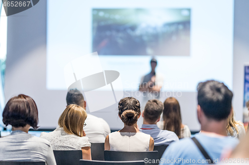 Image of Male business speaker giving a talk at business conference event.