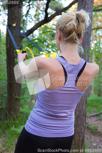 Image of Training with fitness straps outdoors.