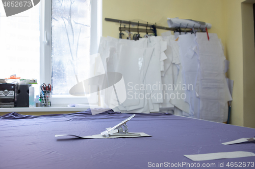 Image of table for cutting matter in a sewing studio and patterns