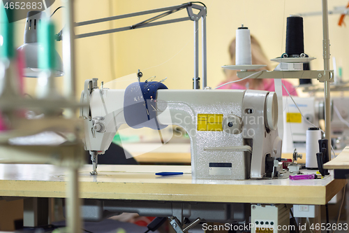 Image of industrial sewing machine in the workshop of the atelier