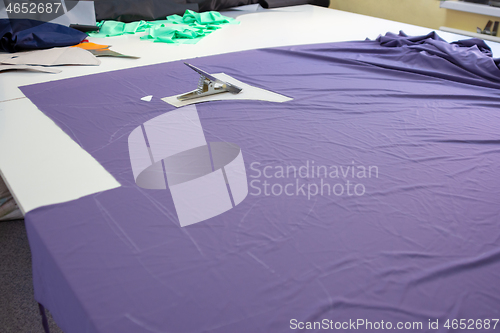 Image of cut matter on a large table in the atelier