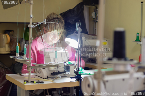 Image of Garment worker works for an industrial sewing machine