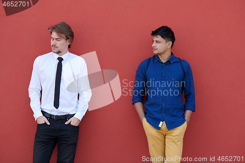 Image of portrait of multiethnic startup business men in front of pink wa