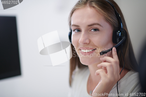 Image of Business woman with headsets at work