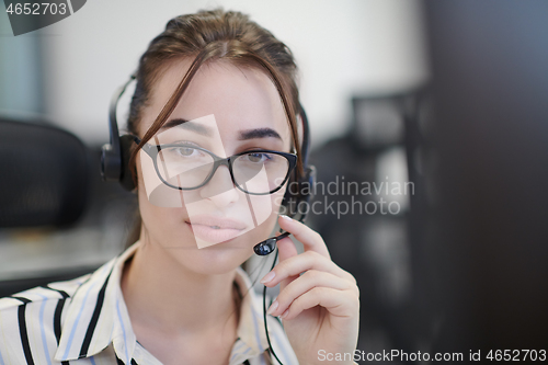 Image of Business woman with headsets at work