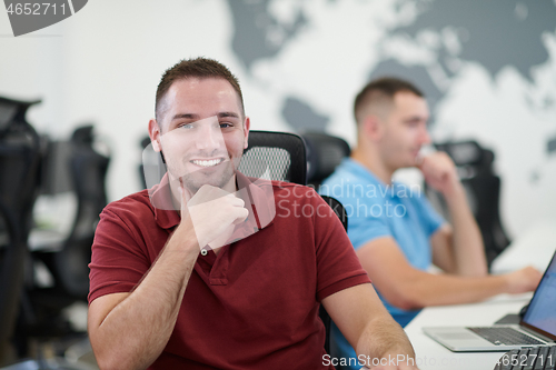 Image of two male software developers working on computer