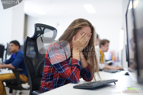 Image of tired casual business woman taking a break from work