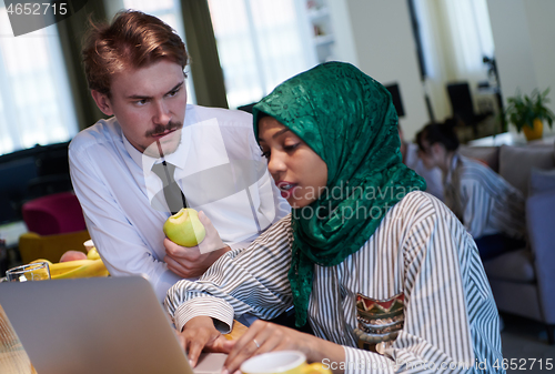 Image of international multicultural business team working together on la