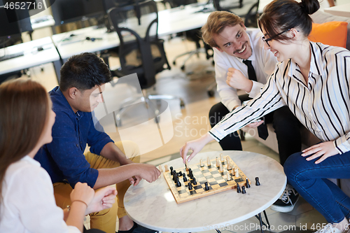 Image of multiethnic group of business people playing chess