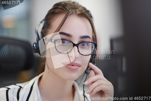 Image of Business woman with headsets at work