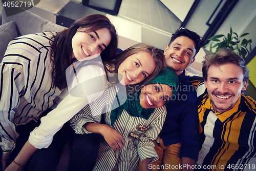 Image of group of casual multiethnic business people taking selfie