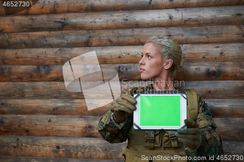 Image of woman soldier using tablet computer